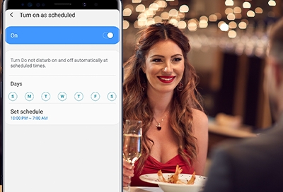 Woman and man at a restaurant with Do Not Disturb menu on a Galaxy phone Woman and man at a restaurant with Do Not Disturb menu on a Galaxy phone