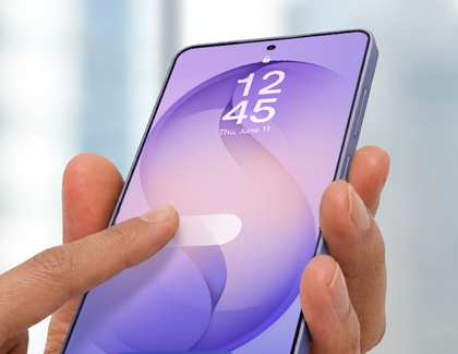 A hand holding a purple Galaxy phone and touching the screen to unlock it.