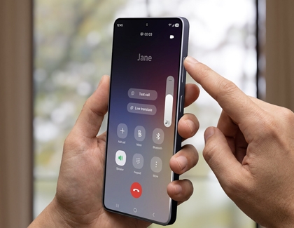 Phone display showing the in-call volume being increased by pressing the volume key.