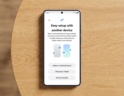 A Galaxy S26 Ultra on a wooden table showing the setup screen with options to transfer data from another device.