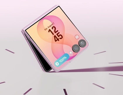 A pink Galaxy Z Flip8 displayed standing partially folded on a white surface showing the cover screen.