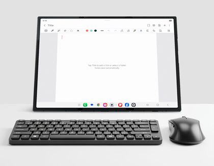 Unfolded Galaxy Z TriFold standing on a desk behind a black wireless keyboard and mouse.