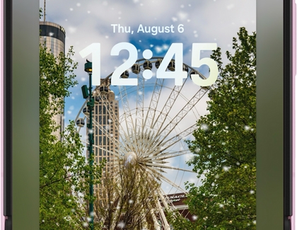 A Galaxy phone lockscreen showing a ferris wheel with falling snow effects.