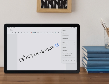 Galaxy Tab A11 Plus on a desk showing a handwritten math equation being solved in Samsung Notes.