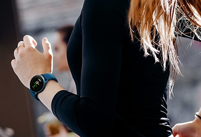 Woman jogging with a Galaxy Watch Active 2 wellness tracker on her wrist Woman jogging with a Galaxy Watch Active 2 wellness and fitness tracker on her wrist