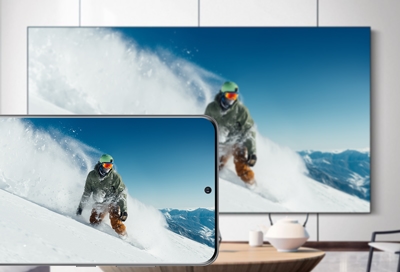 A Samsung TV and S20 displaying the same image of a snowboarder