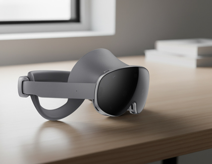 Galaxy XR headset resting on a wooden desk near a window.