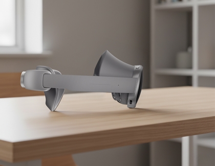 Galaxy XR headset resting on a wooden table in a bright room.