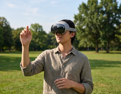 A person using the Galaxy XR headset outdoors while performing a hand gesture.