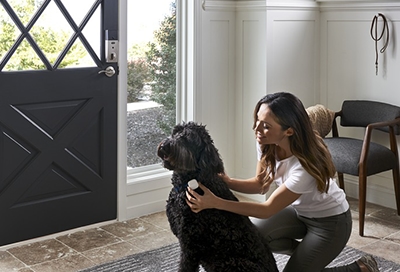 Woman attaching SmartThings Tracker to her dog's collar