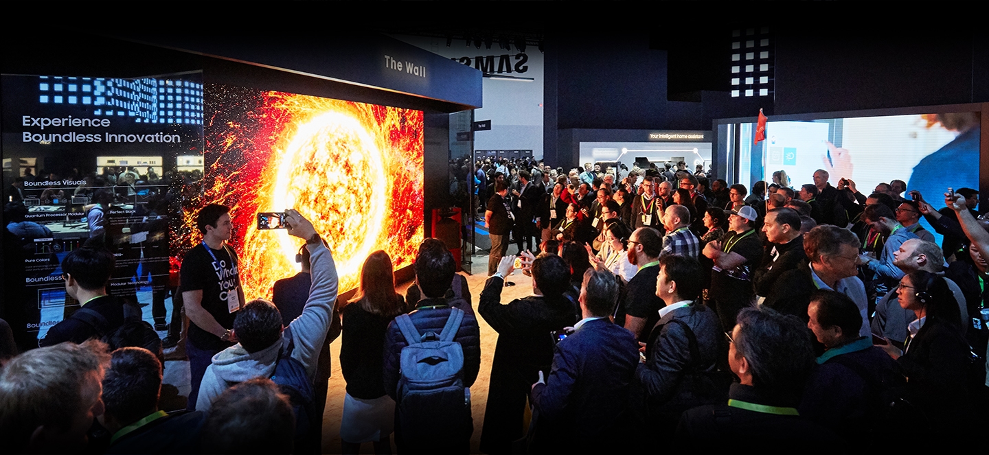 A large crowd of attendees gather around The Wall 2019 on display at the VD zone inside the Samsung booth at CES 2019.