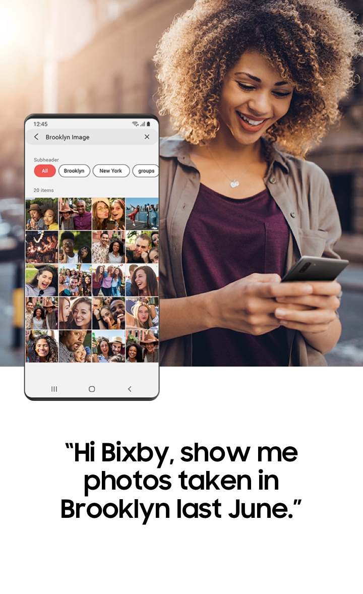 A screen in the Gallery app on a Galaxy phone showing photos with friends during a trip to Brooklyn after searching for 'Brooklyn trip images’ using Bixby’s Galaxy control features.