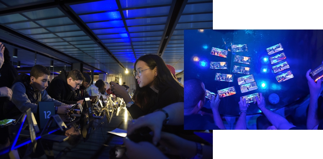 People playing Fortnite in Battle Royale mode and some Samsung Galaxy S10+ smartphones getting set up for finals round