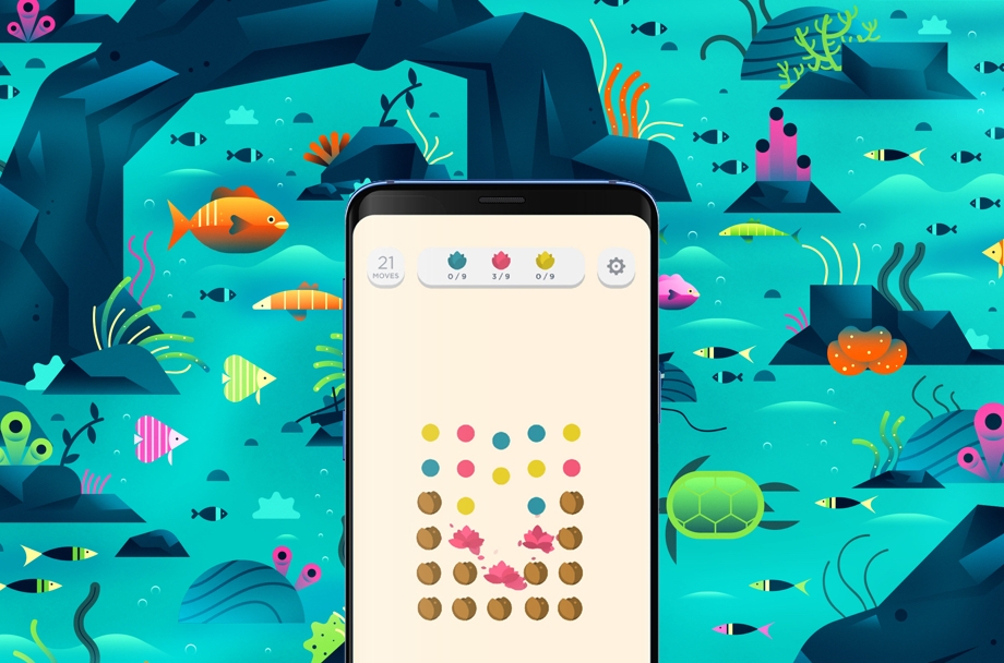 A phone showing Two Dots gameplay is layed over underwater artwork from the same game