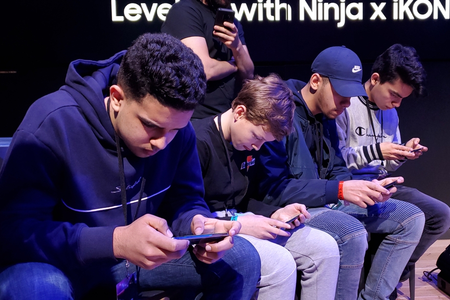 Four gamers of various ages battle on their Samsung Galaxy mobile gaming devices at Samsung 837.