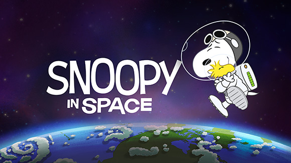 A promo shot for the new Apple TV+ orginal show, Snoopy in Space. The image shows Snoopy in a space suit floating above the earth while hugging Woodstock, his yellow bird sidekick. The show's name is written in a fun font to the center of the shot and to the left of Snoopy.