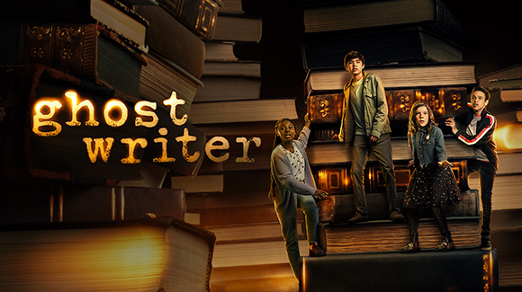 A promo shot for  the new Apple TV+ orginal show, Ghostwriter. The image shows four teenagers climbing on extra-large books in what seems to be a larger-than-life library. The show's name is to the left of the shot in what looks like typewriter font.