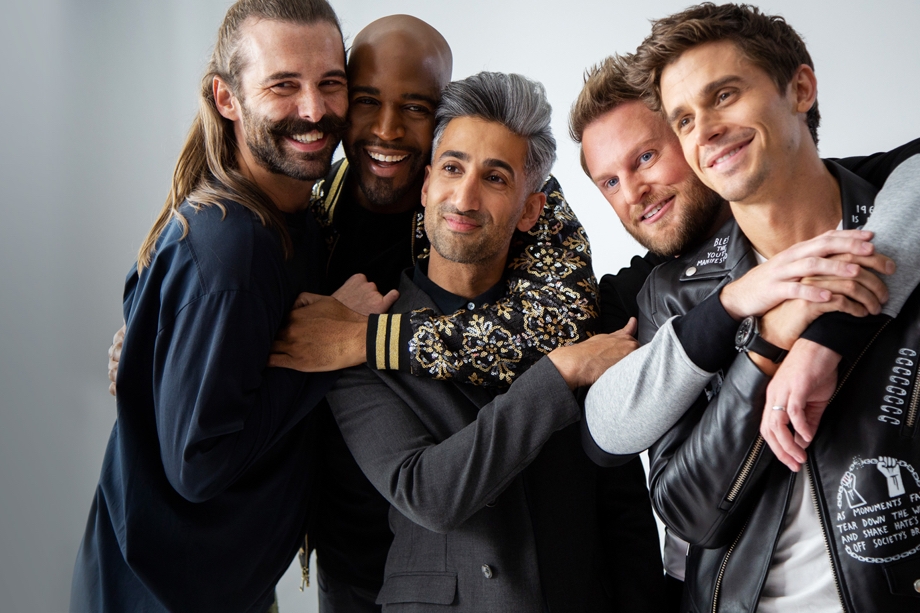 Scene from hit series Queer Eye via Netflix mobile app that shows the main cast smiling into the camera while hugging one another