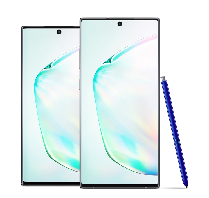 A Galaxy Note10+ stands slightly in front of a Galaxy Note10 phone in an upright position as a blue S Pen leans against the side of the Galaxy Note10+
