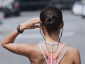 Woman getting ready for workout using her Samsung Galaxy Gear Fit2