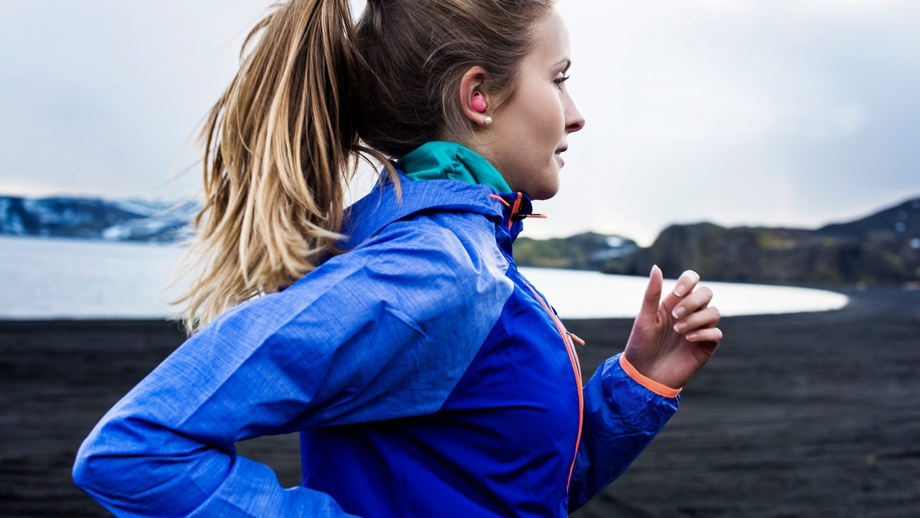 Photo of woman going for a run with Gear IconX