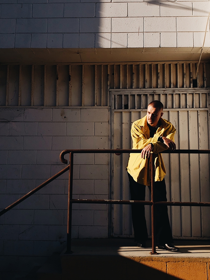 Man leaning against railing.