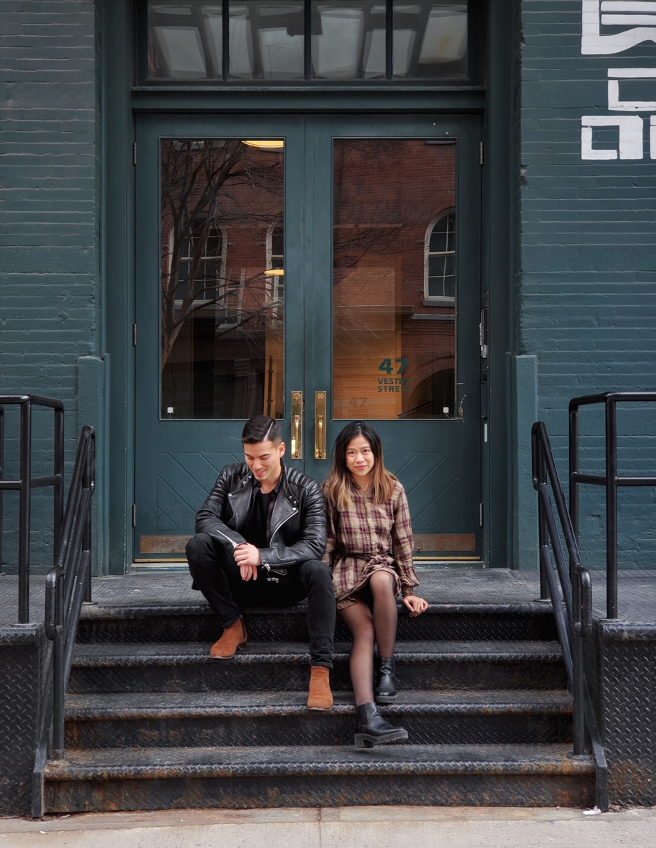Photo of man and woman sitting on shop's stoop