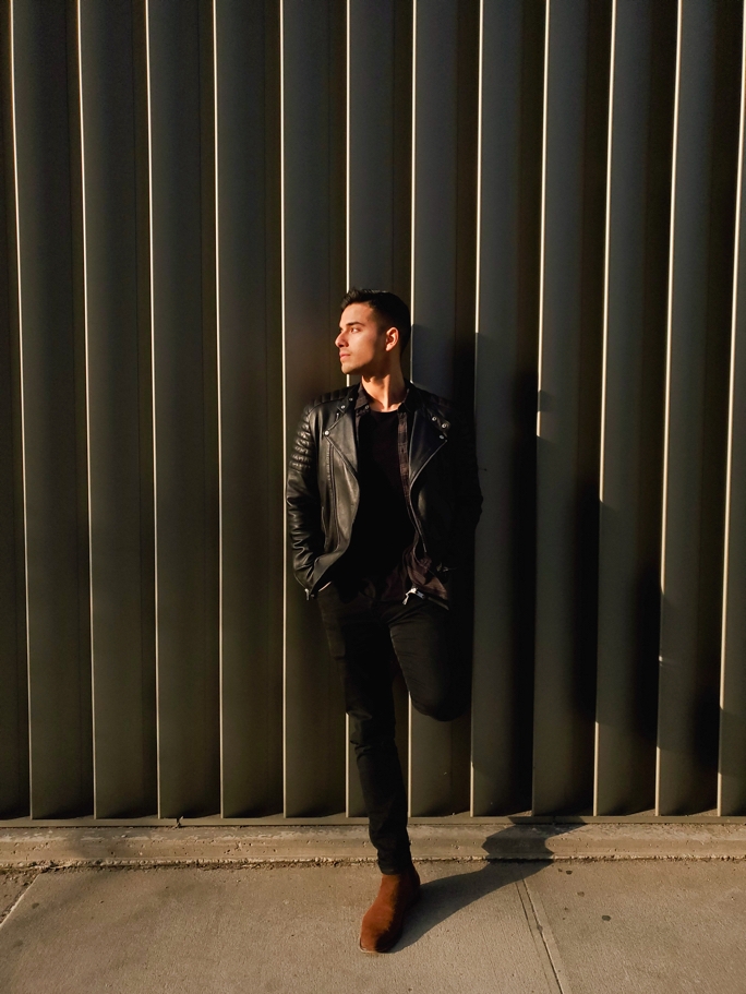 Back of a prism white Galaxy S10+ phone with Dual Aperture lens, with the front of a black Galaxy S10+ phone slightly overlaying on top