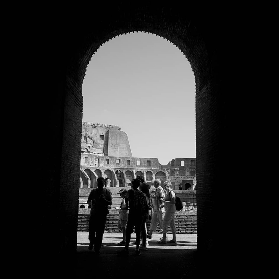People standing in archway. 