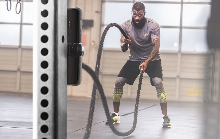 Image of man working out with ropes in gym for resistance training 