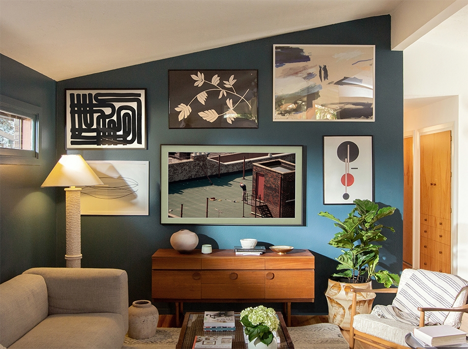 Various artworks, including Golfer in New York, USA (1993) by Thomas Hoepker displayed on The Frame, hang on the living room wall in Kirsten Grove's home.