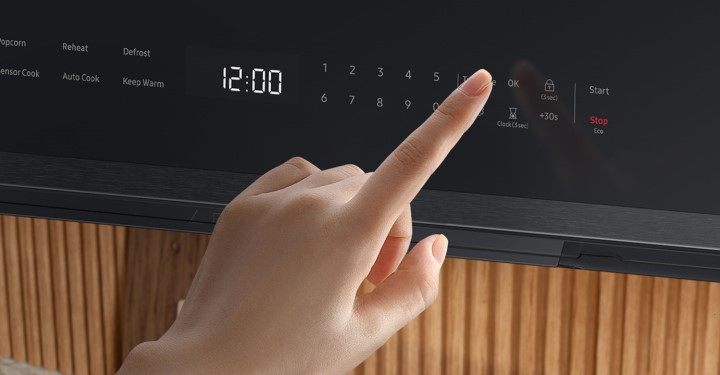 Person using touch screen on Samsung Over the Range Microwave