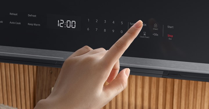Person using touch screen on Samsung Over the Range Microwave