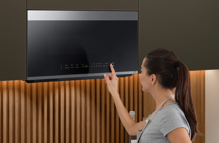 Person using touch screen on Samsung Over the Range Microwave