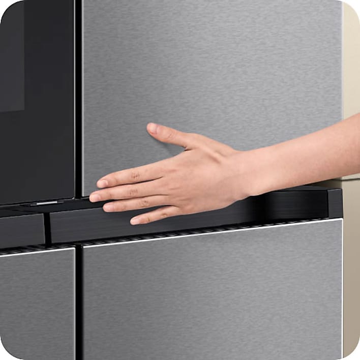 Persons hand using touch screen on Samsung Family Hub refrigerator