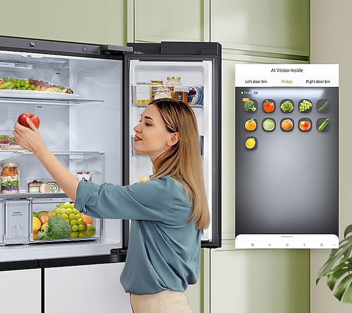 Woman stocking up her Samsung Bespoke Family Hub refrigerator