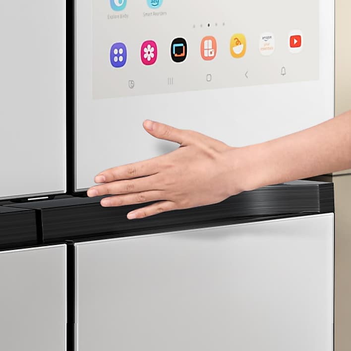 Persons hand using touch screen on Samsung Family Hub refrigerator