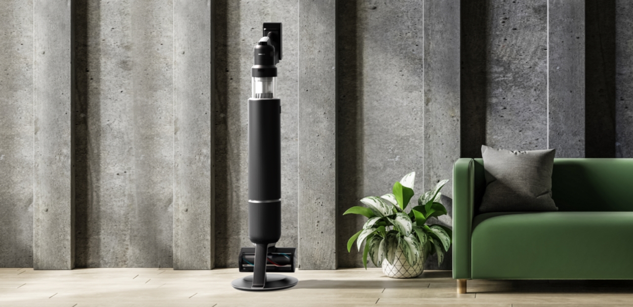 Matte Black Jet Stick Vacuum in Modern Living Room Next to Green Couch