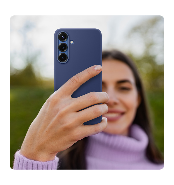 A person holds a Galaxy S25+ installed with the Silicone Case in Blue.