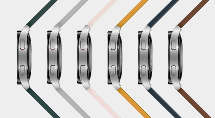 Six Watch4 devices are placed on its side, arranged sideways to show the band color of each …