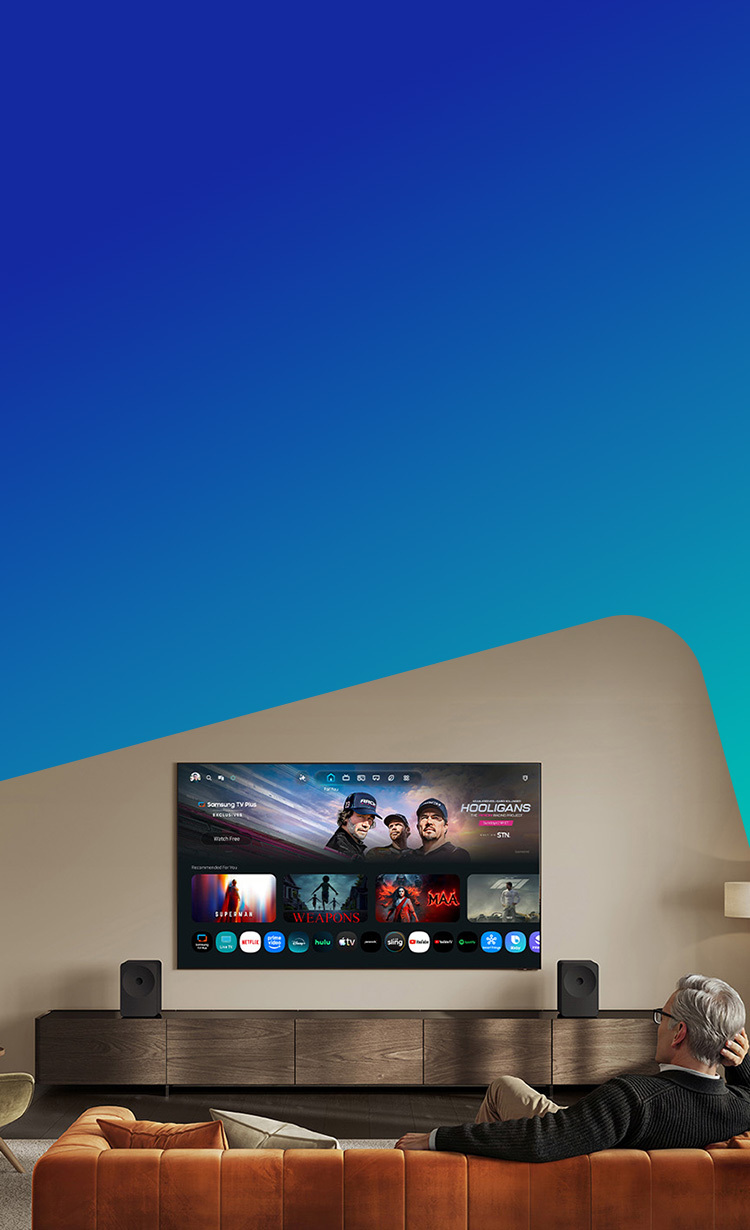 Man relaxing on a couch watching a Samsung Smart TV in a living room