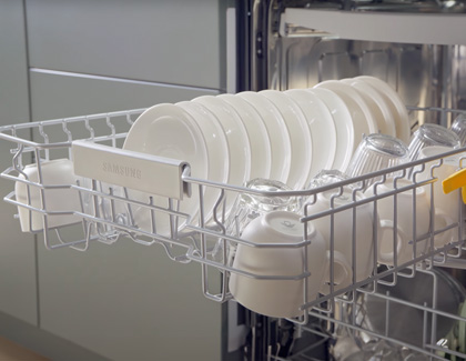 Samsung dishwasher filled with ceramic plates and glass cups