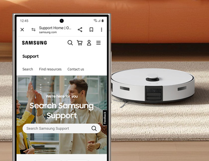 Samsung Support website displayed on a Galaxy phone with a Samsung Jet Bot vacuum in the background