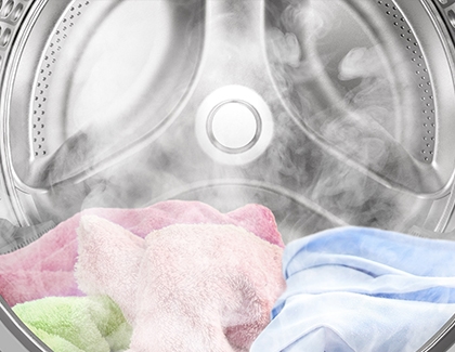 The inside of a Samsung washing machine with towels and steam rising from it