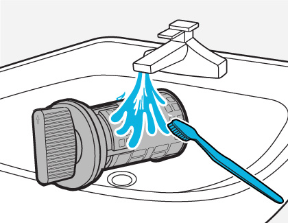 Illustration of a drain filter being cleaned on a sink using water and a toothbrush