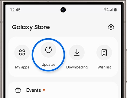Screen of a Samsung Galaxy phone showing the Galaxy Store interface with highlighted 'Updates' button among other options including 'My apps', 'Downloading', and 'Wish list'.