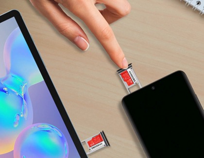 A finger inserting a microSD card into a Galaxy phone