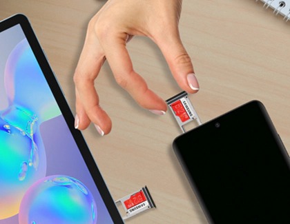 A hand removing a microSD card from a Galaxy phone