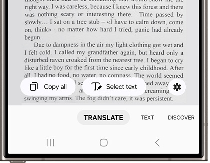 Camera being pointed at the text of a book while providing Translate, Text, and Discover options