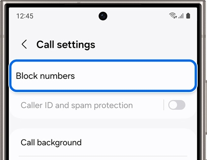 Screen of a Galaxy phone displaying the call settings menu. The 'Block numbers' option is highlighted, with additional settings for 'Caller ID and spam protection' and 'Call background' listed below.